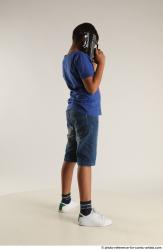 TIMBO STANDING POSE WITH GUN